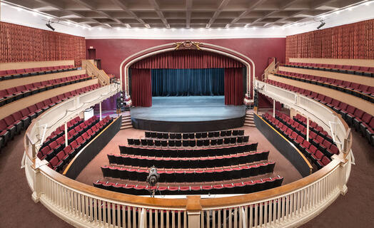 Empty Theatre with red curtains and a stage