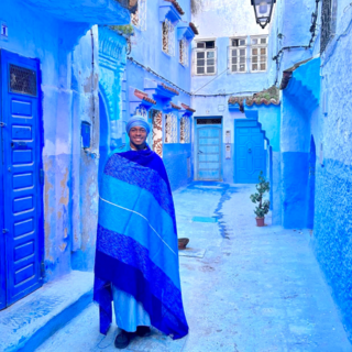 A young adult male stands in the streets of Moracco