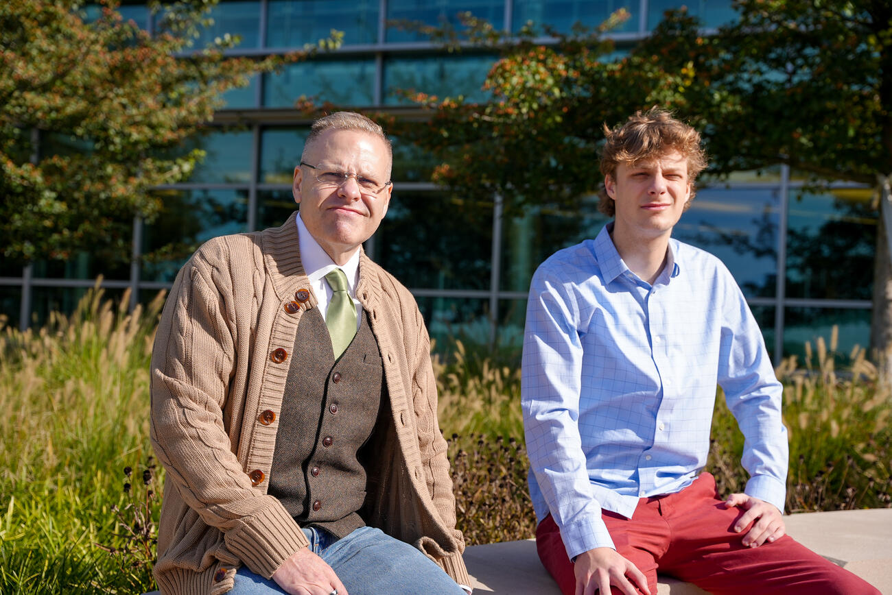 Alum Dominic Byerly sitting with professor Kevin McIntyre.