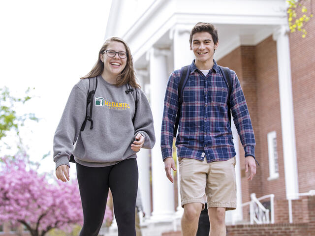 Students walking across campus in Spring.