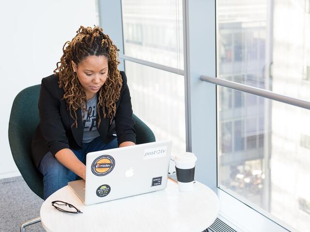 Young adult female using a laptop.