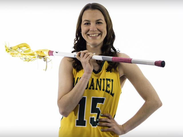 Kaylen Buschhorn poses with a lacrosse stick.