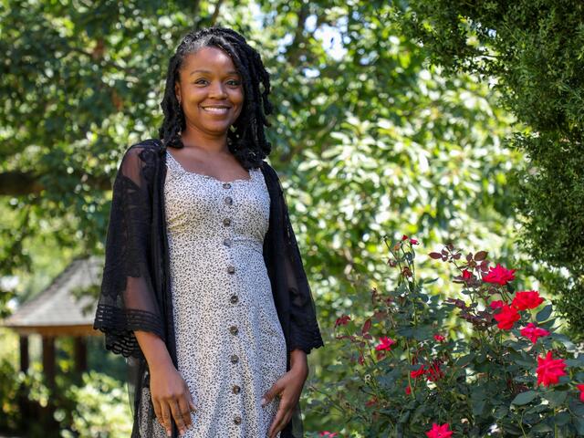 Photo of professor Lyneia Richardson standing outside in a garden.