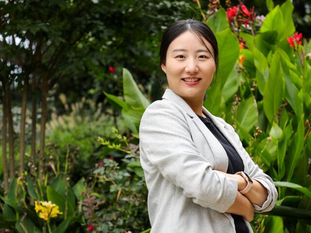 Photo of professor Xuejing Duan standing outdoors on campus.