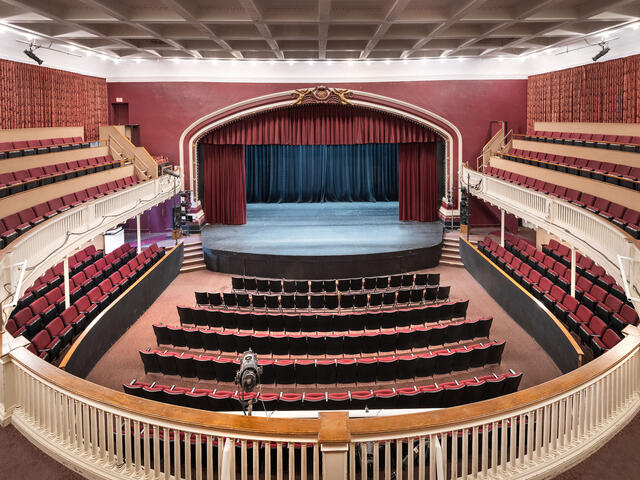 Empty Theatre with red curtains and a stage