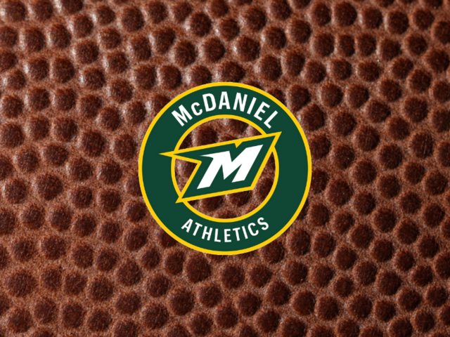 McDaniel Athletics logo on football texture background