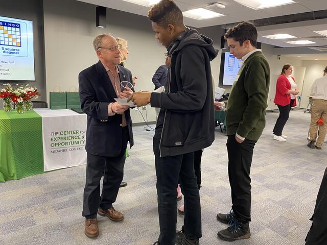 CEO volunteer talking with a student