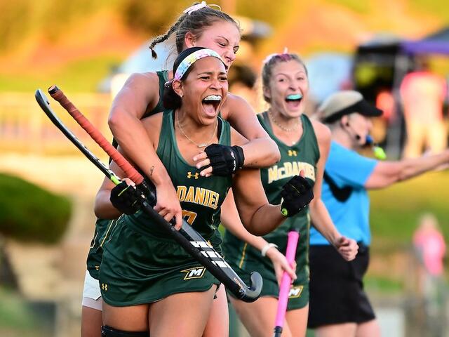 Green Terror field hockey athletes celebrating a goal