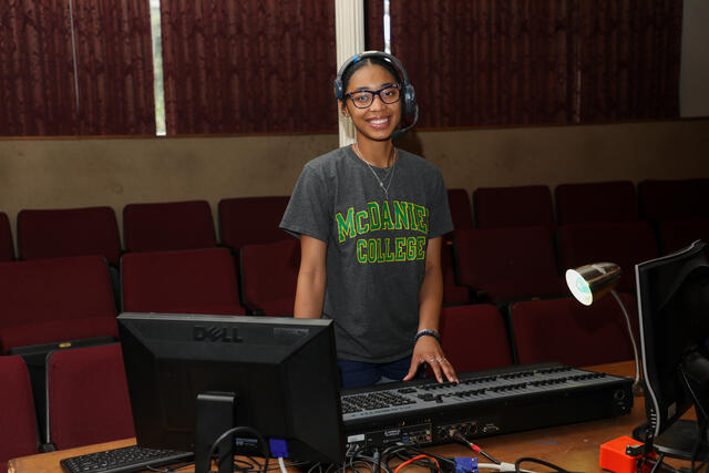 Student Kim Parson at the lightboard in the theatre.