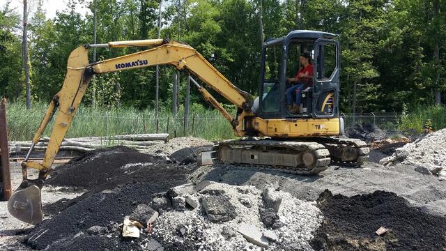 Photo of Perri Freeman using an excavator. 