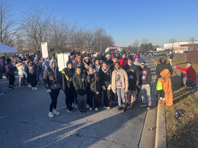 A group photo of students in Find Your Strong at the end of running a 5K.