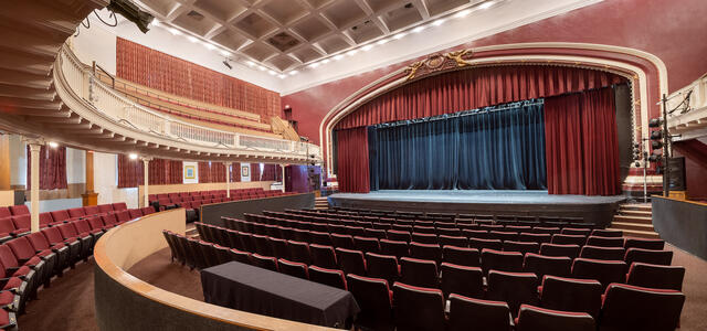 Empty Theatre with red curtains and a stage