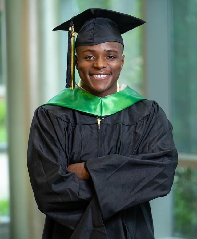 Headshot of Habeeb Baba wearing graduation regalia. 