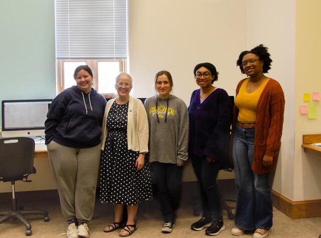 Four summer research students pose with Professor Mary Bendel-Simso.