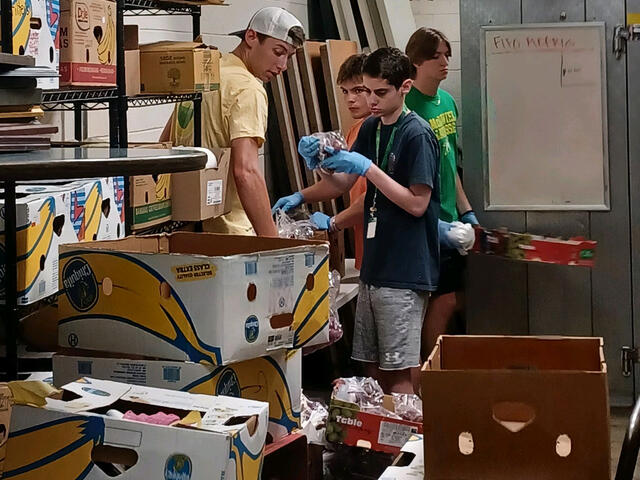 Group of students looking at boxes