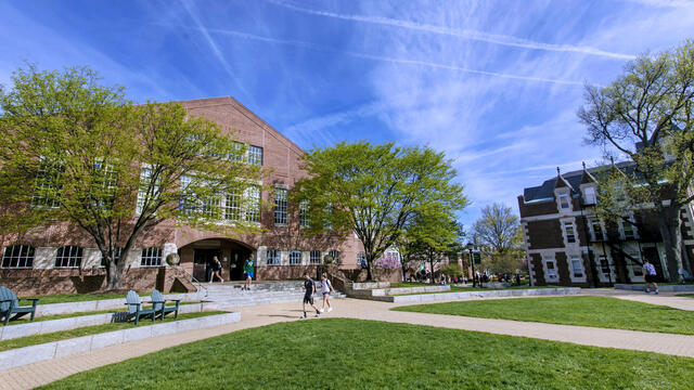 Student walking in front of Hoover Library.