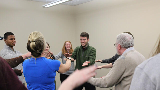 Professor Paul Mazeroff and students participating in the ancient Chinese healing art.