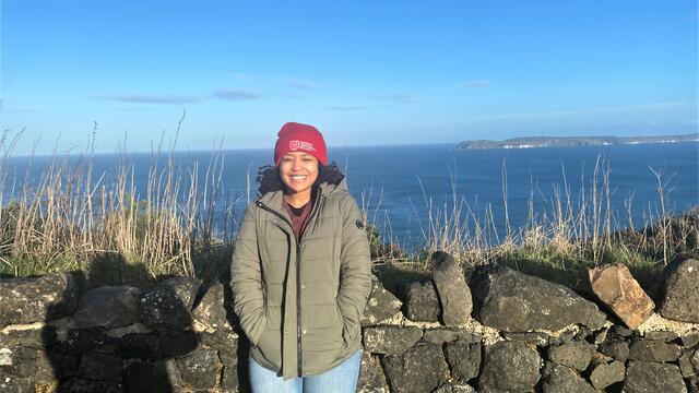 Photo of student Gabbie Gladden in Northern Ireland wearing a beanie hat that reads Queen's University Belfast.