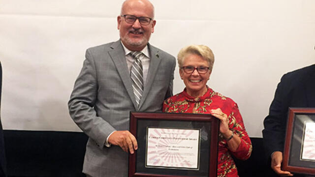 McDaniel President Roger N. Casey with Bonnae Meshulam, executive director of the Boys and Girls Club of Westminster with the Campus Community Partnership Award from Maryland-DC Campus Compact.