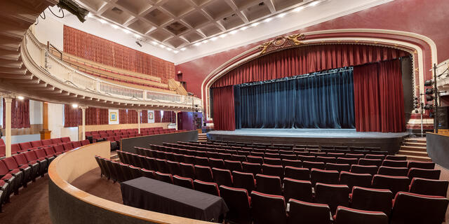 Empty Theatre with red curtains and a stage