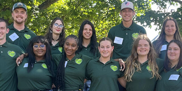 Group of people in green shirts